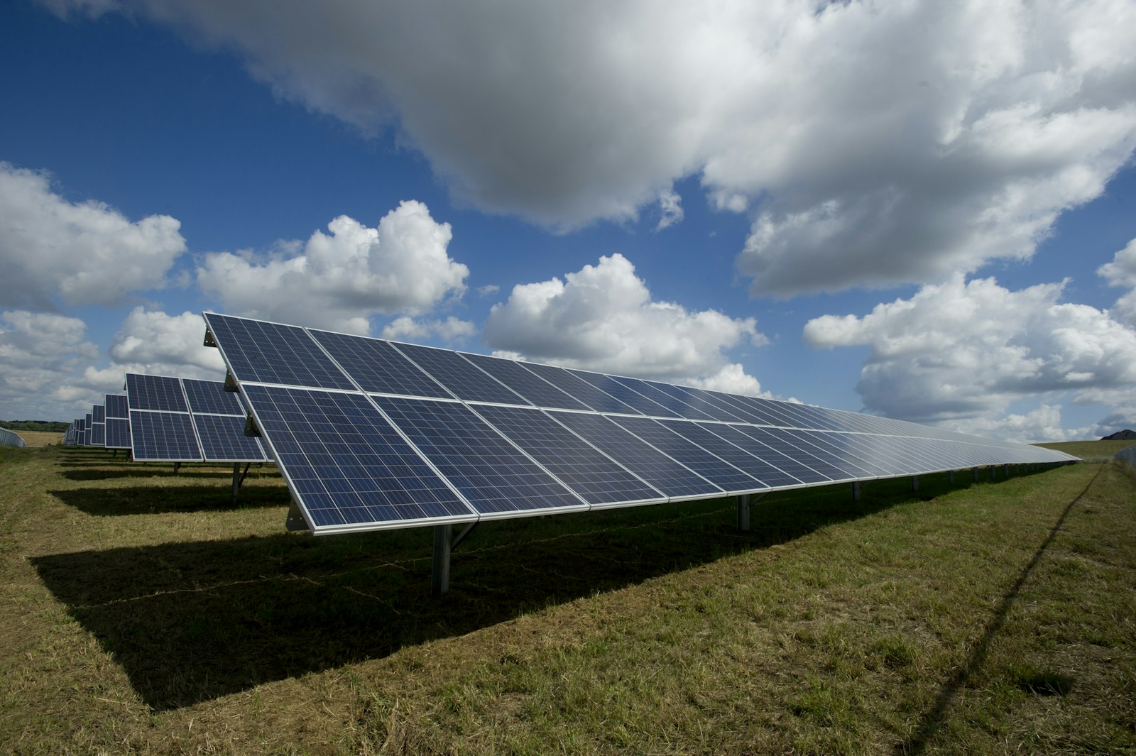 Solar panels in a mountainous Spanish landscape under blue sky